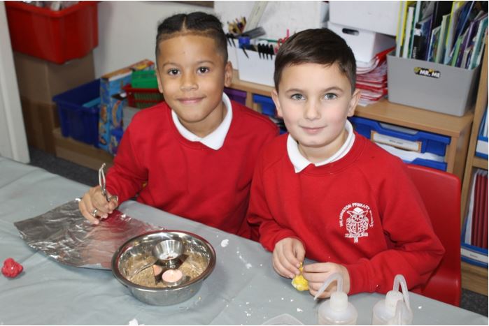 A couple of young children in red uniforms

Description automatically generated