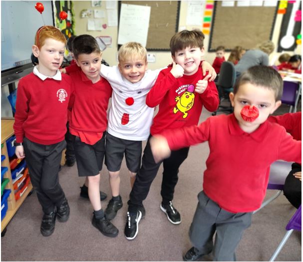 A group of boys in red shirts

Description automatically generated