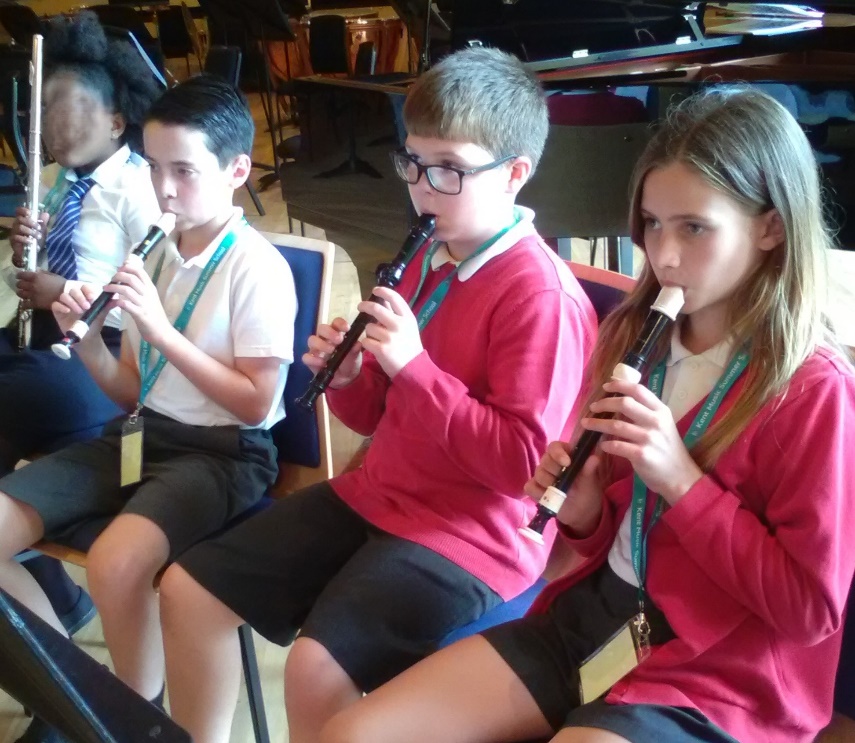 A group of children playing instruments

Description automatically generated