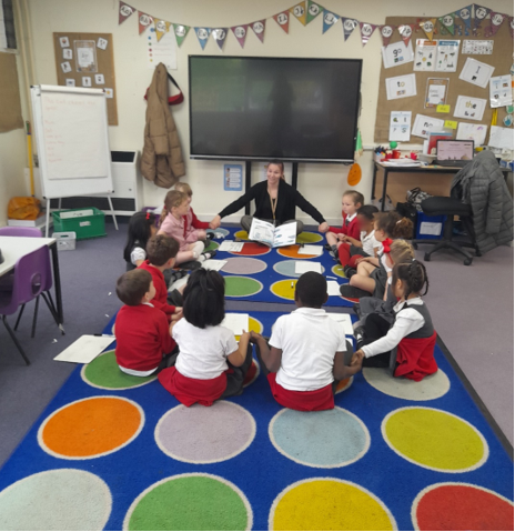 A group of children sitting on a rug in a classroom

Description automatically generated