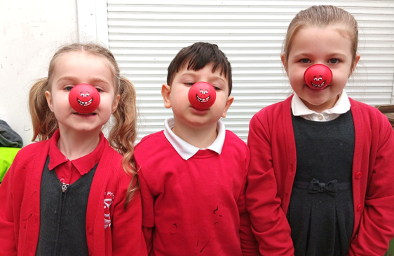 A group of children with red nose caps

Description automatically generated