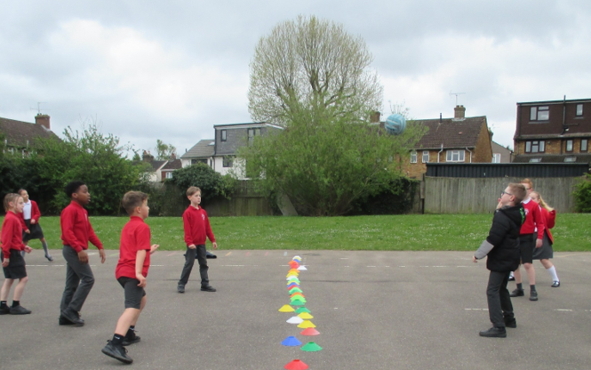 A group of kids playing with colorful kites

Description automatically generated