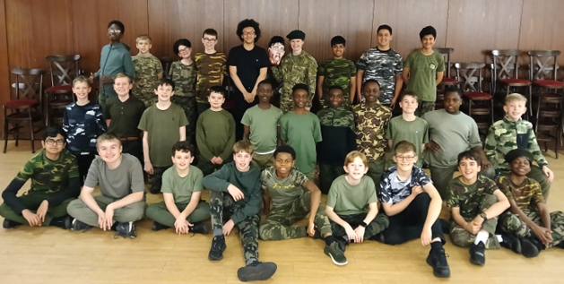 A group of boys in green uniforms posing for a photo

Description automatically generated